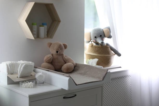 Modern changing table in baby room interior